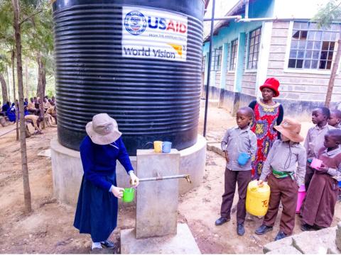 Learners at Central Primary School for the Visually Challenged in Kitui Central Ward fetch water from two 10,000-litre tanks installed at the school by World Vision Kenya during the Kenya Integrated Emergency Response (KIERP) Project in Kitui County. © World Vision Photo/Jared Ontobo